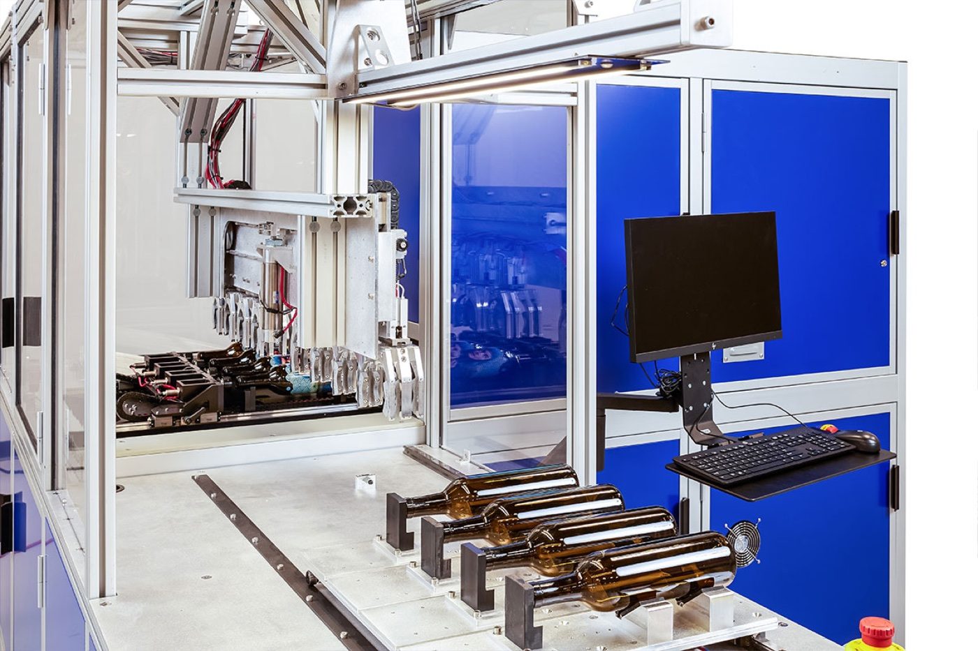 The LSINC cylindrical press at Sun Studio Dubai with bottles loaded on the bed, ready for 360 degree direct printing