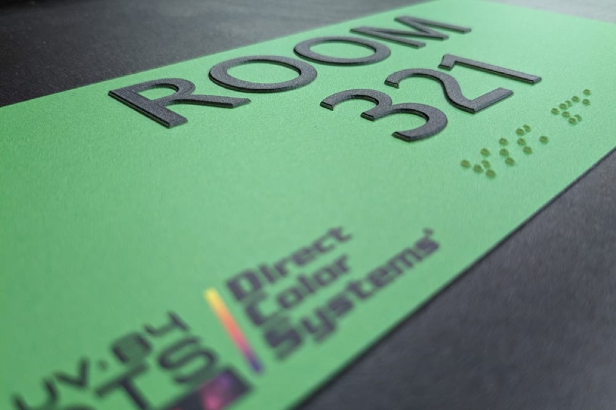 Raised braille dots built up in layered ink