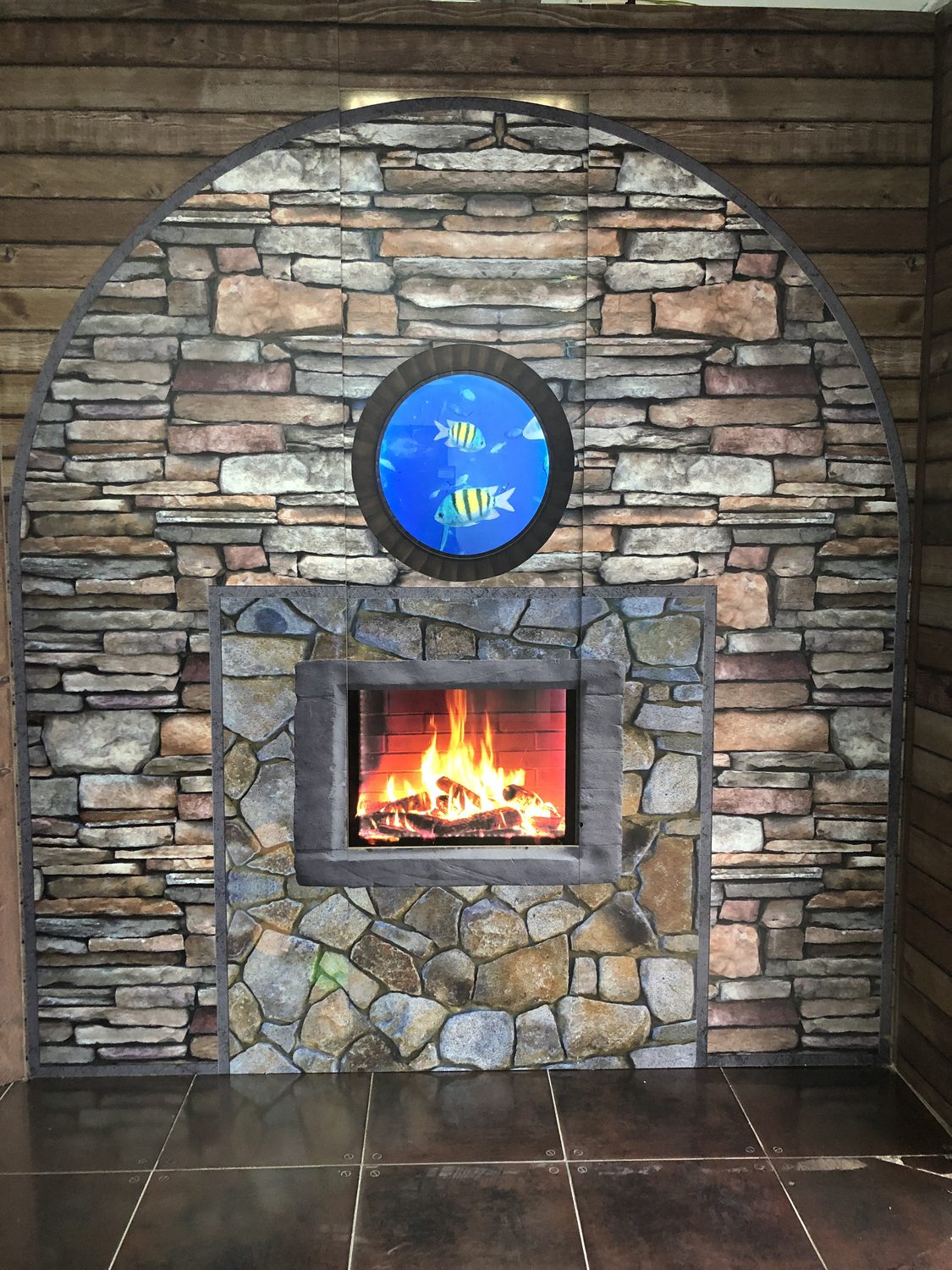 A printed MDF feature wall with a stone effect, an arched profile and inset aquarium and fireplace openings